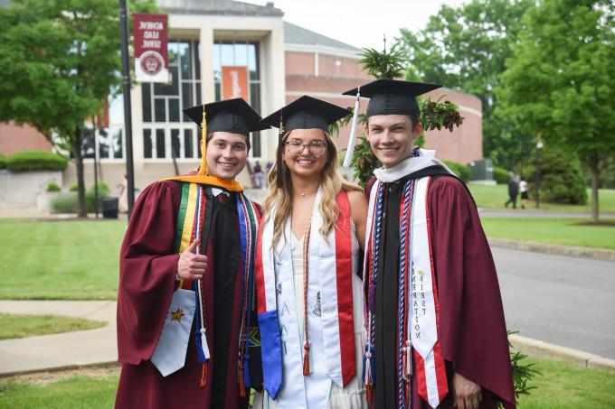 photo of three students at commencement